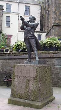 Statue with man looking through telescope